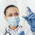 close up woman with syringe serum