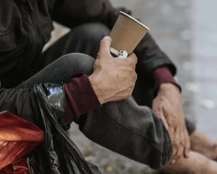 side view homeless man holding cup 1 1