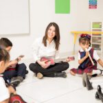 portrait attractive hispanic brunette teaching music group preschool pupils