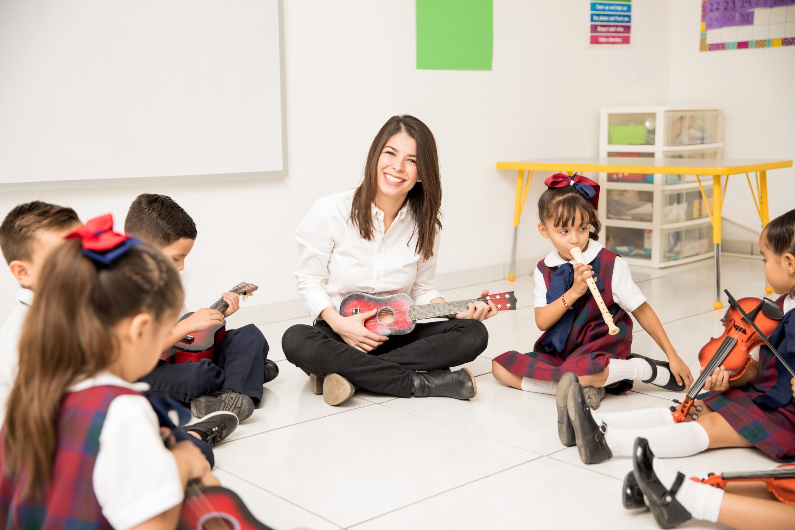 portrait attractive hispanic brunette teaching music group preschool pupils scaled